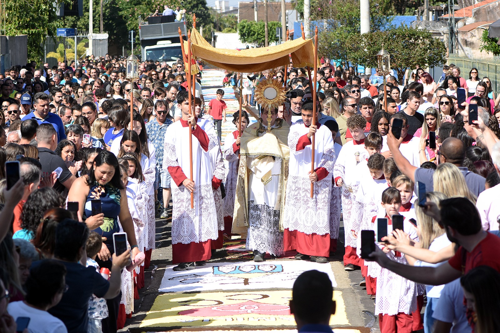 Religiosos e católicos caminham  por tapete decorado  na Minibasílica